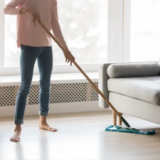 Lady cleaning vinyl flooring | Premiere Floor Covering