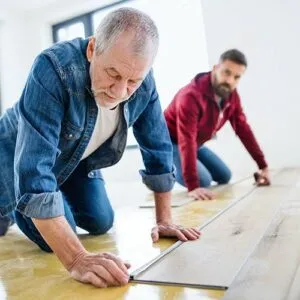 Worker installing vinyl floor | Premiere Floor Covering
